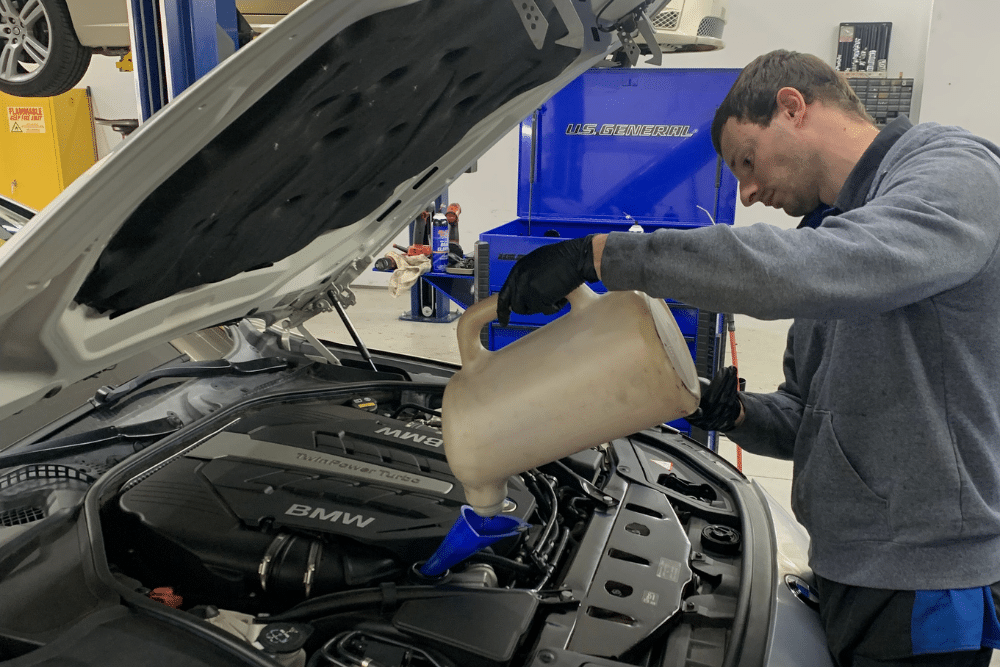 Summer Heat Fluid Service, Fluid Service in Mooresville, NC At Rock Solid Auto Care. Image of fluid service performed by a technician